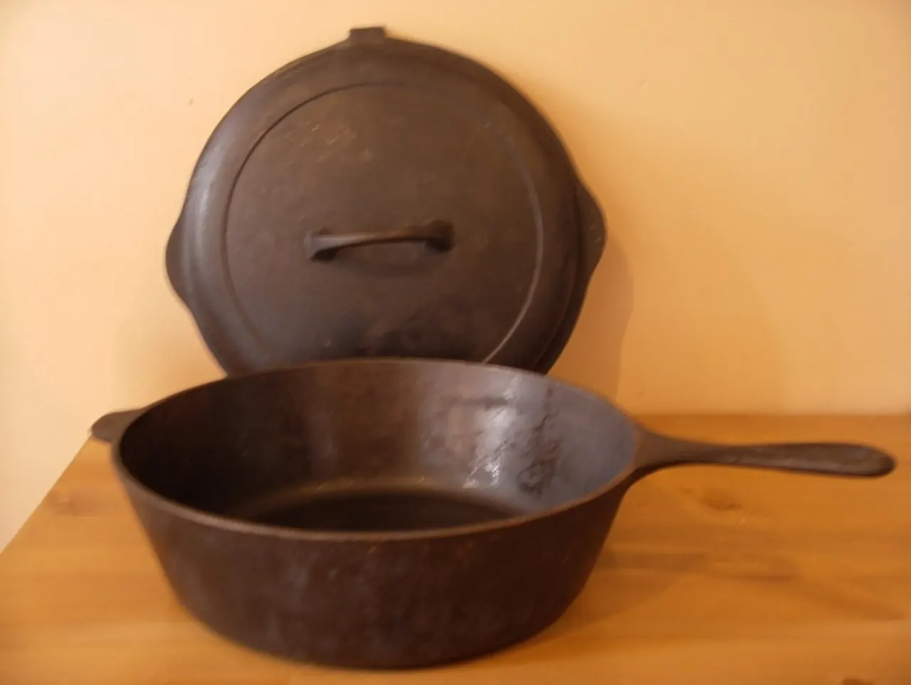 Empty cast-iron skillet with lid on a counter