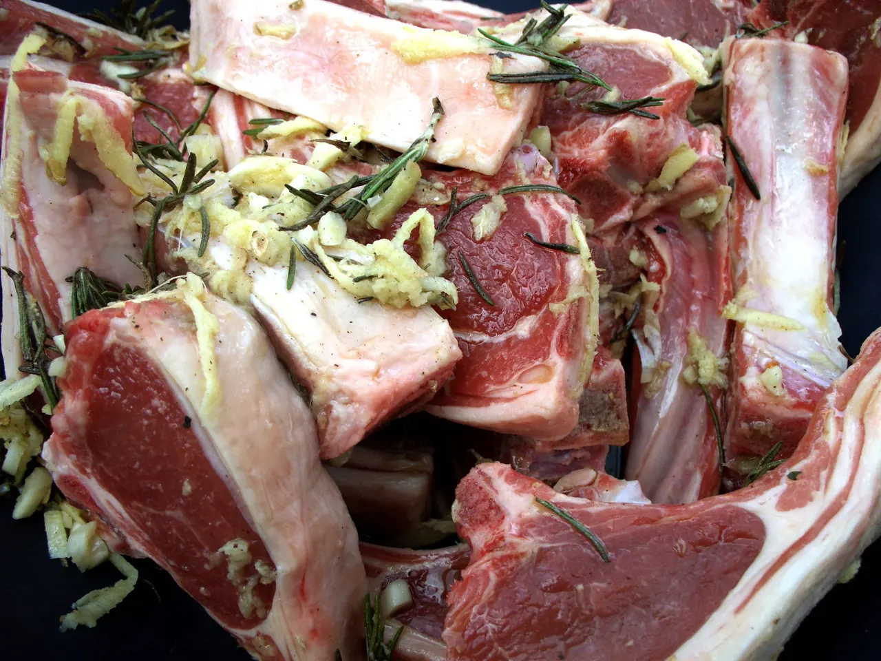 Raw lamb cutlets with ginger, garlic, and rosemary before cooking