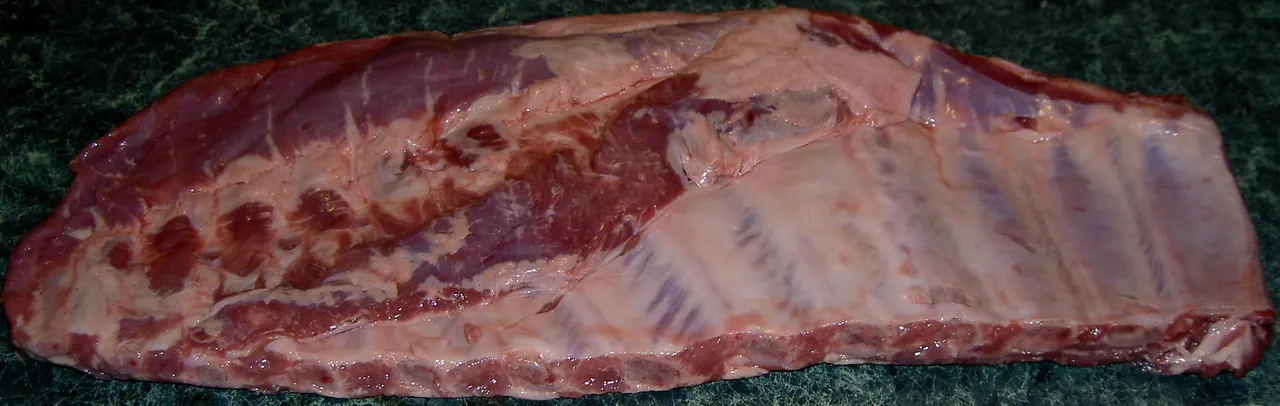 Uncooked pork spare ribs rack on a counter