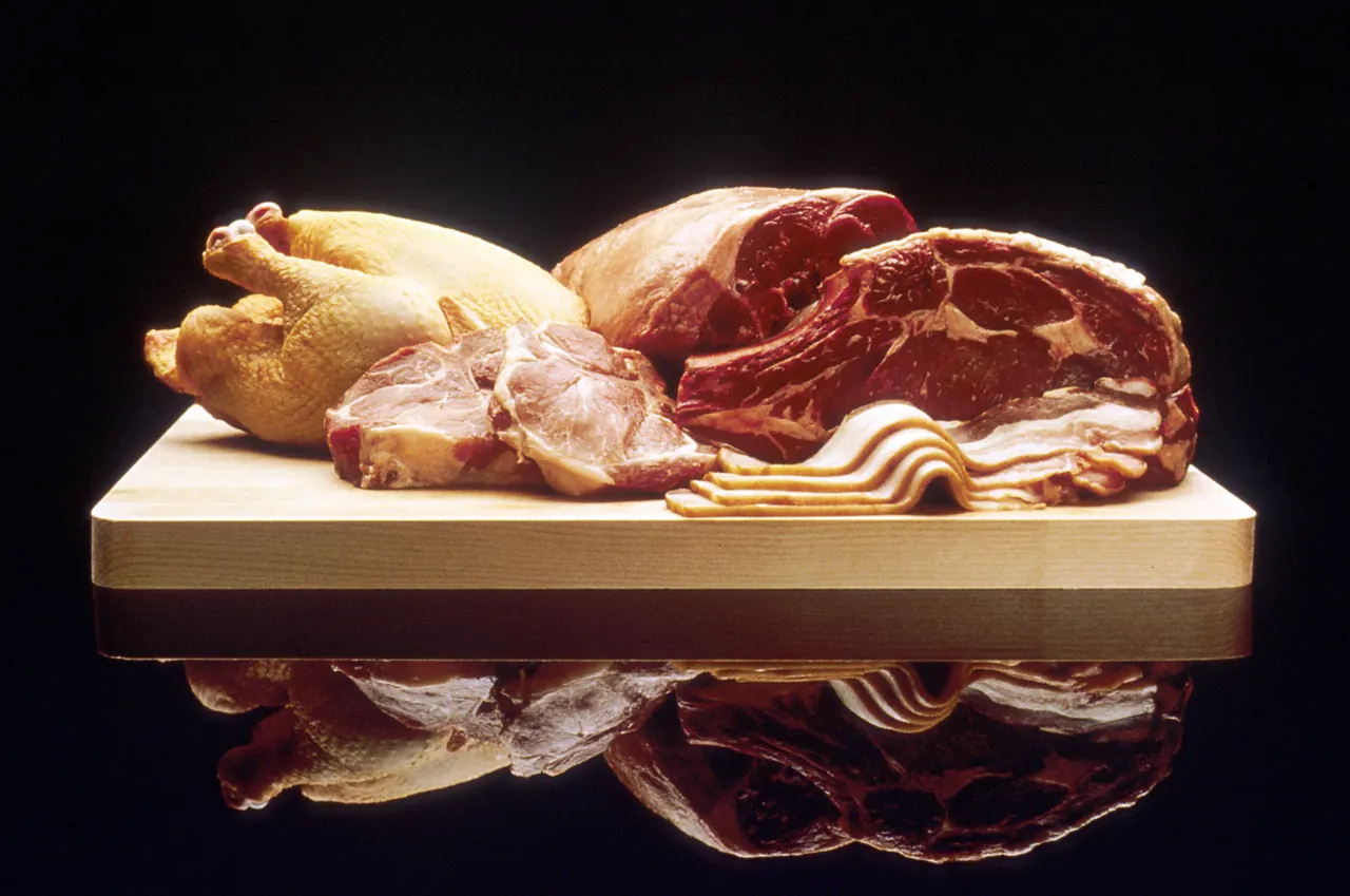 Raw beef, pork, and poultry portions arranged on a cutting board