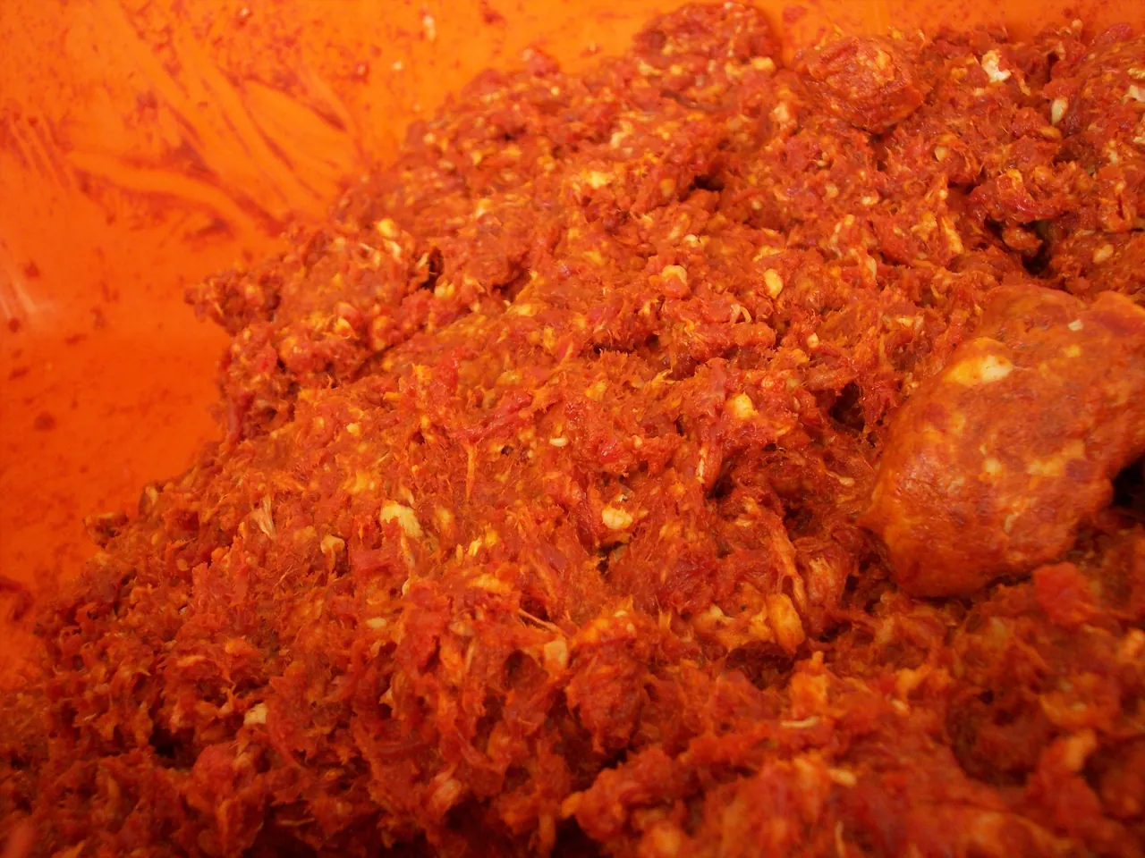 Ground meat and trim prepared for sausage making in a bowl